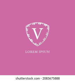 Letter V Intial logo design template. Suitable for Insurance, fashion and beauty product. Luxury silver decorative floral shield illustration. Isolated on pink color background.