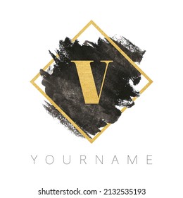 Letter V logo design. Black watercolor brush stroke with gold letter and gold square frame.