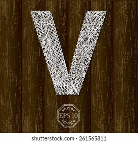 Letter V, made with threads on pins on wooden background. Part of collection.
