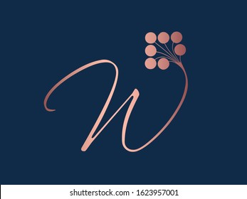 Letter W logo with decorative floral elements.Ornamental calligraphy lettering sign.Rose gold alphabet initial icon isolated on dark background.Elegant,organic,luxury,beauty style character shape.