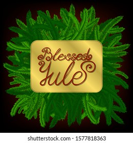 lettering blessed yule, decorated with green pine-tree branches