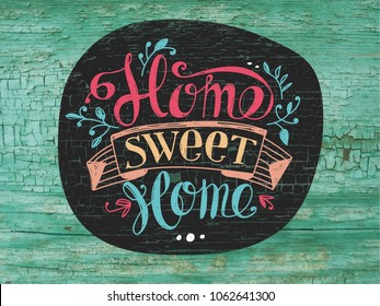 Lettering "Home sweet home". Hand drawing. The texture of the old painted wood. Green house wall