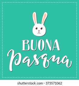 Lettering illustrative composition. Happy Easter in Italian and cute bunny head on top. Dashed frame on turquoise background.