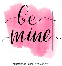 Lettering inscription be mine. Valentine's Day card. Pink watercolor stain on background.