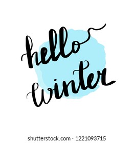 Lettering inscription hello winter. Blue watercolor stain on background.