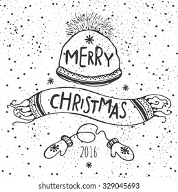 The lettering - MERRY CHRISTMAS. Winter hat with ornament, scarf and mittens. Winter postcard.