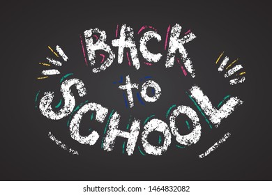 Lettering phrase back to school for banner, print, card, poster. Modern calligraphy slogan by white chalk on black chalkboard. Hand written words back to school.