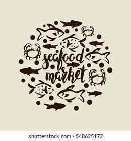 Lettering seafood market, round design, hand drawn with brush pen, inc. Vector. Logo. Could be used for fish market. Vector. Calligraphic inscription seafood market with fish and crab.