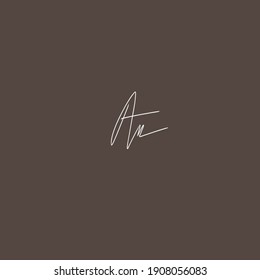Am letters, light brown background handwritten logo