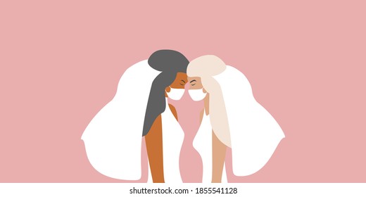 Lgbt wedding. Beautiful female lesbian couple on their wedding day, dressed in bride dresses, wearing medical masks. Wedding in times of coronavirus concept