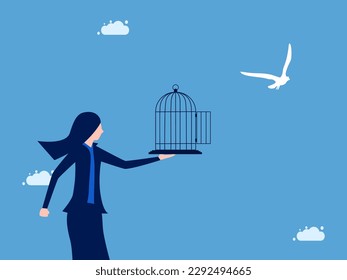 Liberation and freedom. Businesswoman releases the bird from the cage