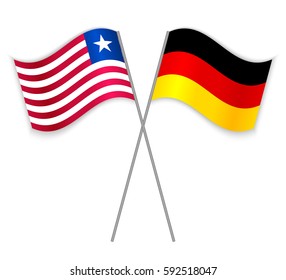 Liberian and German crossed flags. Liberia combined with Germany isolated on white. Language learning, international business or travel concept.