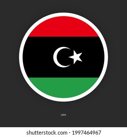 Libya circle flag icon with white border on dark grey background. Libya button flag icon isolated on barely dark background.