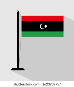 Libya flag on pole, isolated on gray background