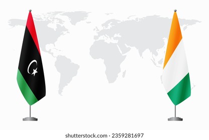 Flaggen Libyens und Côte d'Ivoires für offizielle Treffen vor dem Hintergrund der Weltkarte.