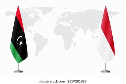 Libya and Monaco flags for official meeting against background of world map.