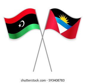 Libyan and Antiguan crossed flags. Libya combined with Antigua and Barbuda isolated on white. Language learning, international business or travel concept.