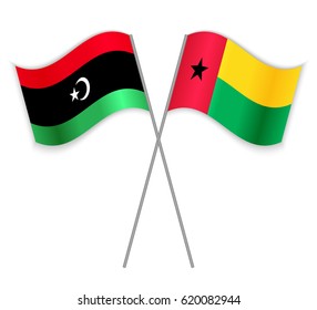 Libyan and Bissau-Guinean crossed flags. Libya combined with Guinea-Bissau isolated on white. Language learning, international business or travel concept.