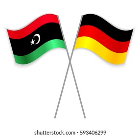 Libyan and German crossed flags. Libya combined with Germany isolated on white. Language learning, international business or travel concept.