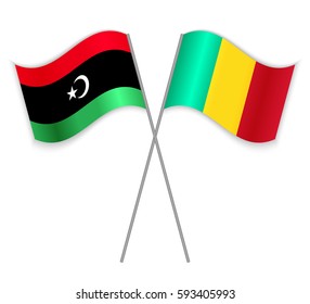 Libyan and Guinean crossed flags. Libya combined with Guinea isolated on white. Language learning, international business or travel concept.