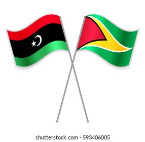 Libyan and Guyanese crossed flags. Libya combined with Guyana isolated on white. Language learning, international business or travel concept.