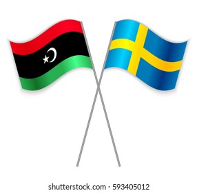 Libyan and Swedish crossed flags. Libya combined with Sweden isolated on white. Language learning, international business or travel concept.