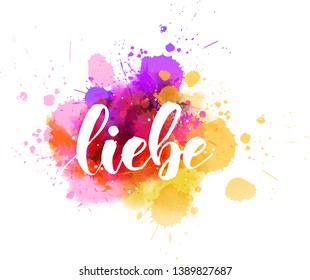 Liebe - Love in German. Handwritten modern calligraphy lettering text on abstract watercolor paint splash background.