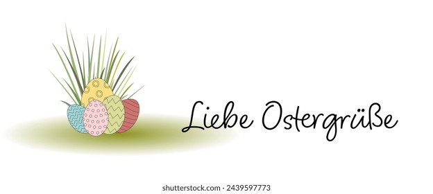 Liebe Ostergrüße - text in German language - Easter greetings. Greeting card with colorful Easter eggs in the grass.