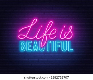 Life is Beautiful neon lettering on brick wall background.