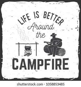 Life is better around the campfire. Vector illustration. Concept for shirt or print, stamp or tee. Vintage typography design with campfire, pot on the fire, man with guitar silhouette.