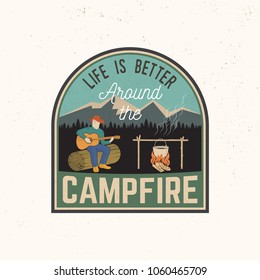 Life is better around the campfire. Vector illustration. Concept for shirt or print, patch, stamp or tee. Vintage typography design with campfire, pot on the fire, man with guitar silhouette.