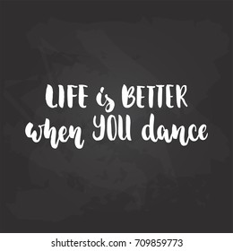 Life is better when you dance - lettering dancing calligraphy quote drawn by ink in white color on the black chalkboard background. Fun hand drawn lettering inscription