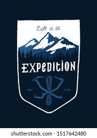 life is an expedition - mount range and crossed ice axes vintage shield shaped typography t-shirt design for screen printing