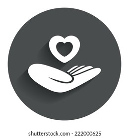 Life insurance sign. Hand holds human heart symbol. Health insurance. Circle flat button with shadow. Modern UI website navigation. Vector