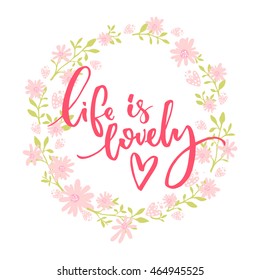 Life is lovely. Whimsical quote, brush lettering at pink and green floral wreath.