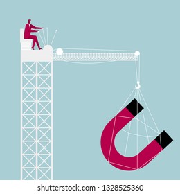 Lifting magnet through the tower crane. Businessman driving a tower crane.