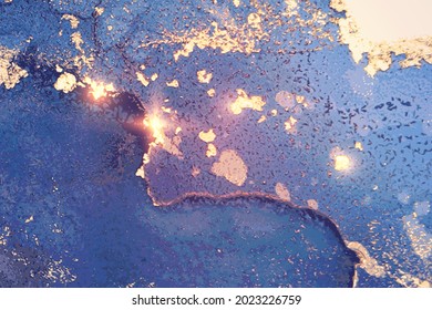 Light blue and gold abstract marble texture background. Luxury wallpaper with paint splashes and color waves. Modern liquid art illustration for poster, flyer, brochure design with shining glitter.
