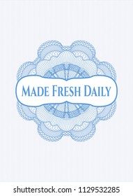 Light blue money style emblem or rosette with text Made Fresh Daily inside