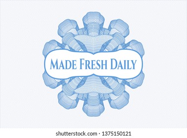 Light blue money style emblem or rosette with text Made Fresh Daily inside