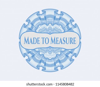 Light blue money style rosette with text Made to Measure inside