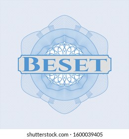 Light blue passport style rosette with text Beset inside
