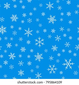 Light blue snowflakes seamless pattern on blue Christmas background.