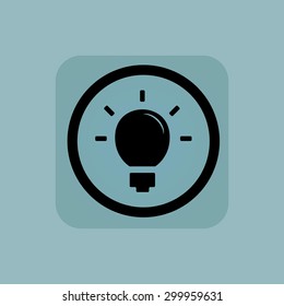 Light bulb in circle, in square, on pale blue background