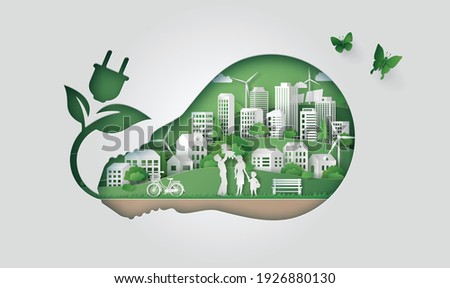 Light bulb with green city inside symbolizing renewable energy and sustainability.