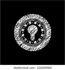 light bulb icon drawn on a blackboard