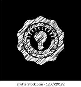 light bulb icon drawn on a chalkboard