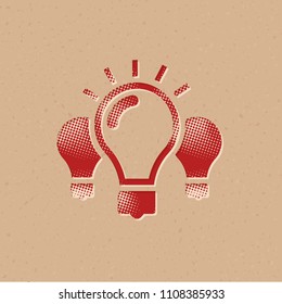 Light bulb icon in halftone style. Grunge background vector illustration.