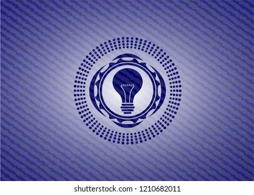 light bulb icon inside badge with denim background