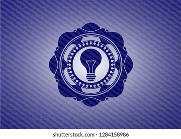 light bulb icon inside badge with denim texture