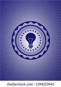 light bulb icon inside badge with denim texture